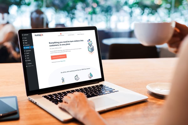 macbook-pro-mockup-featuring-a-person-holding-a-coffee-2325-el1